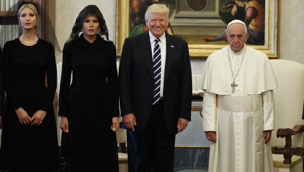 A photograph of Ivanka, Melania, and the Donald meeting with Pope Francis. Ivanka and Melania wear dour expressions on their faces, while Donny is grinning ear to ear.